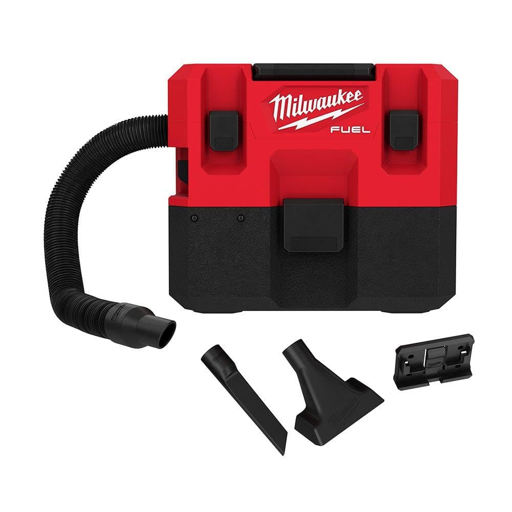 A Milwaukee M12 Fuel cordless vacuum in red and black, featuring a compact design with a flexible hose, shown with additional nozzles and a wall-mounting bracket.