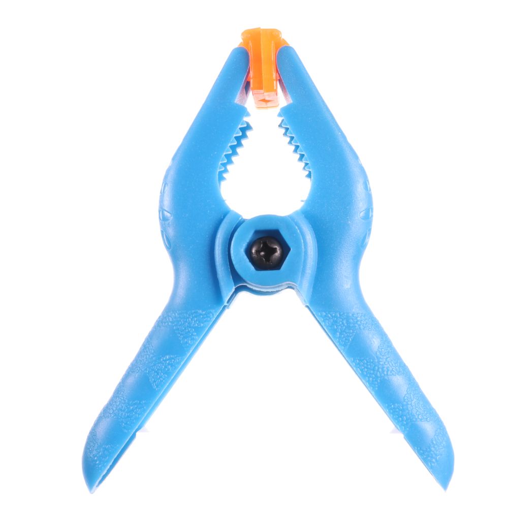 Small blue spring clamp featuring textured handles, serrated edges, and an orange adjustable jaw tip.