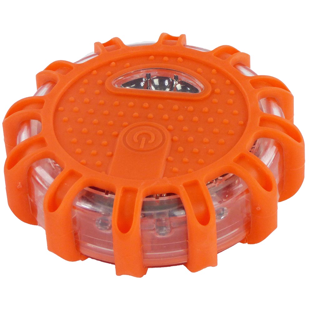 Round LED light with rugged rubberized shell, textured top surface, and integrated clear window with button