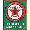 Rustic Texaco sign displaying the classic red star logo and bold lettering, framed by a green and red border.