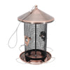 Cylindrical metal bird feeder with copper-toned roof, black mesh body, and circular base with perch loops
