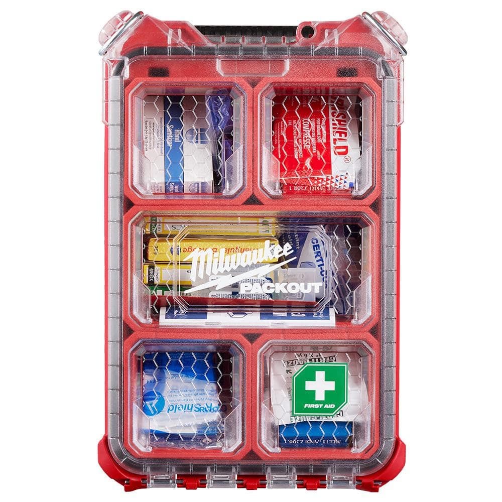 Milwaukee Packout case with clear lid, red frame, and six internal compartments filled with organized first aid items