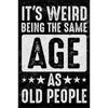 Humorous sign with bold, distressed text reading "It's Weird Being the Same Age as Old People" on a dark background.