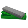 Dual-sided abrasive block featuring straight edges and compact green tray for protective storage